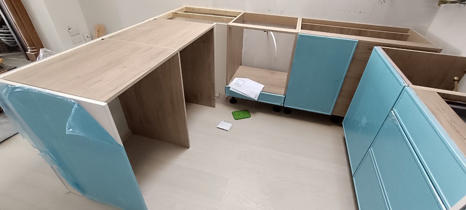 Kitchen carcasses and teal units being assembled